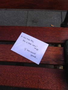 Anonymous note sitting on a street bench.
